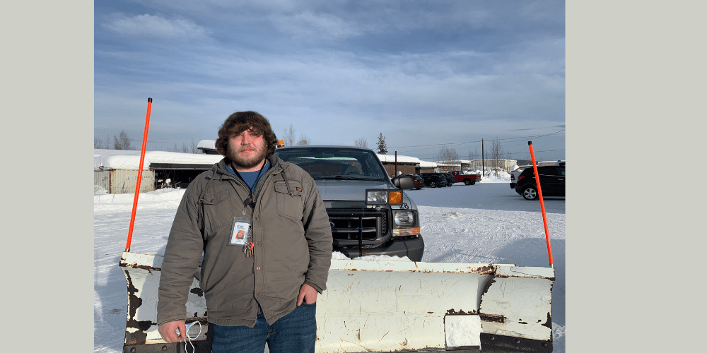 man standing in front of pick up truck w snow plow